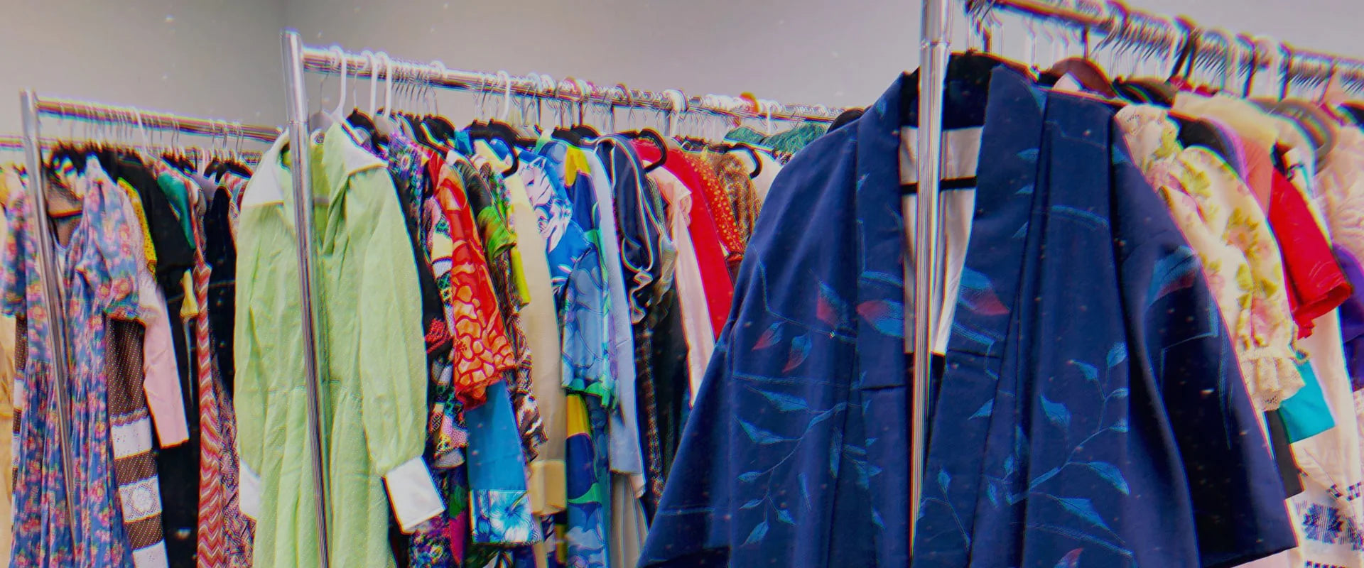 Clothing rack with various colorful garments in a store setting